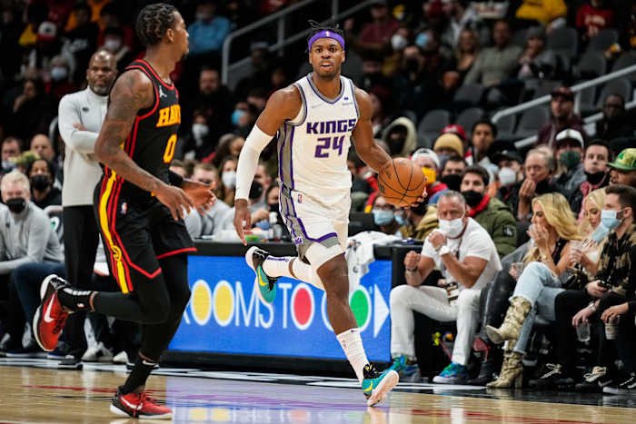 Jan 26, 2022; Atlanta, Georgia, USA; Sacramento Kings guard Buddy Hield (24) dribbles up the court against Atlanta Hawks guard Delon Wright (0) during the game at State Farm Arena.
